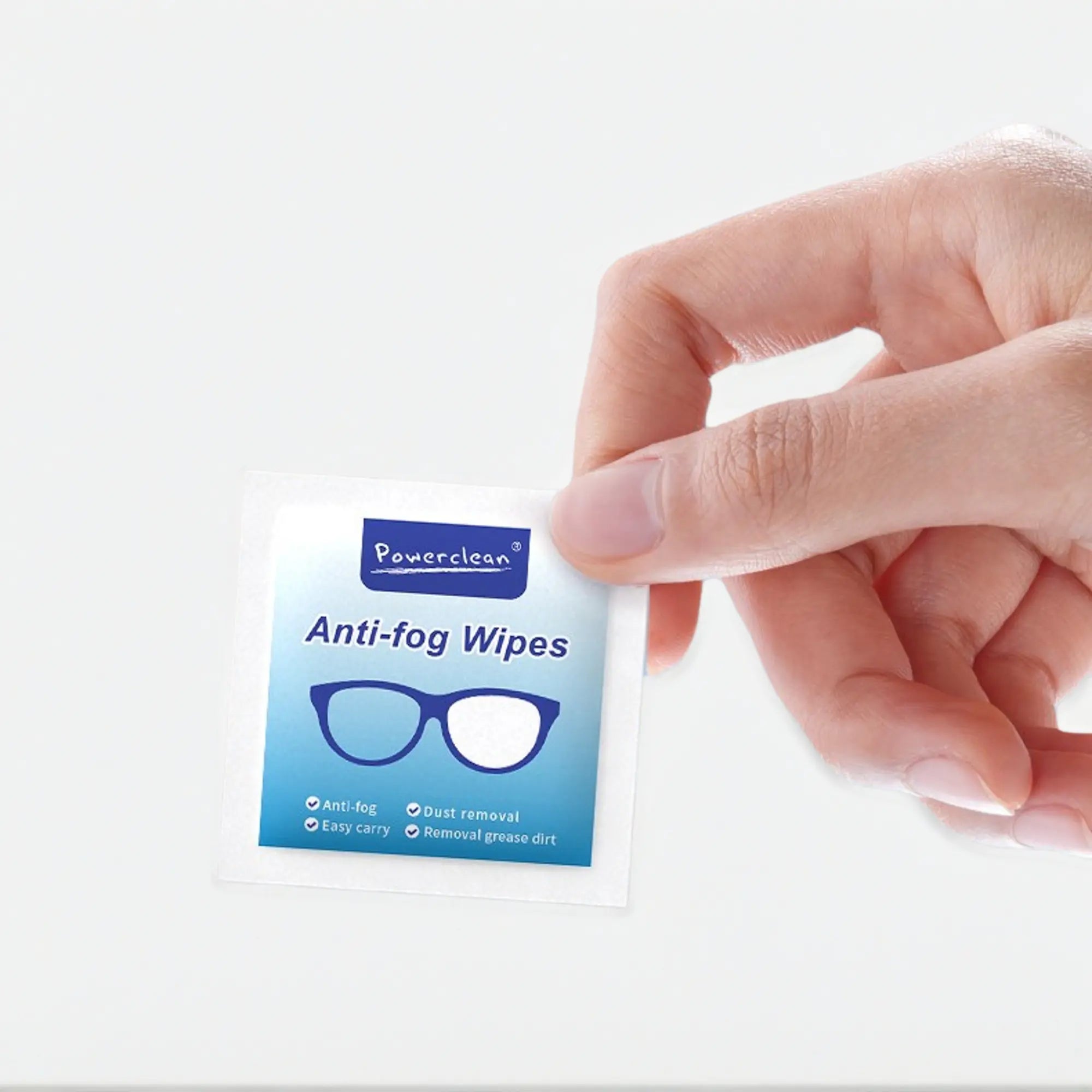 Hand holding a single pack of Powerclean Anti-fog Wipes for glasses cleaning and anti-fog protection